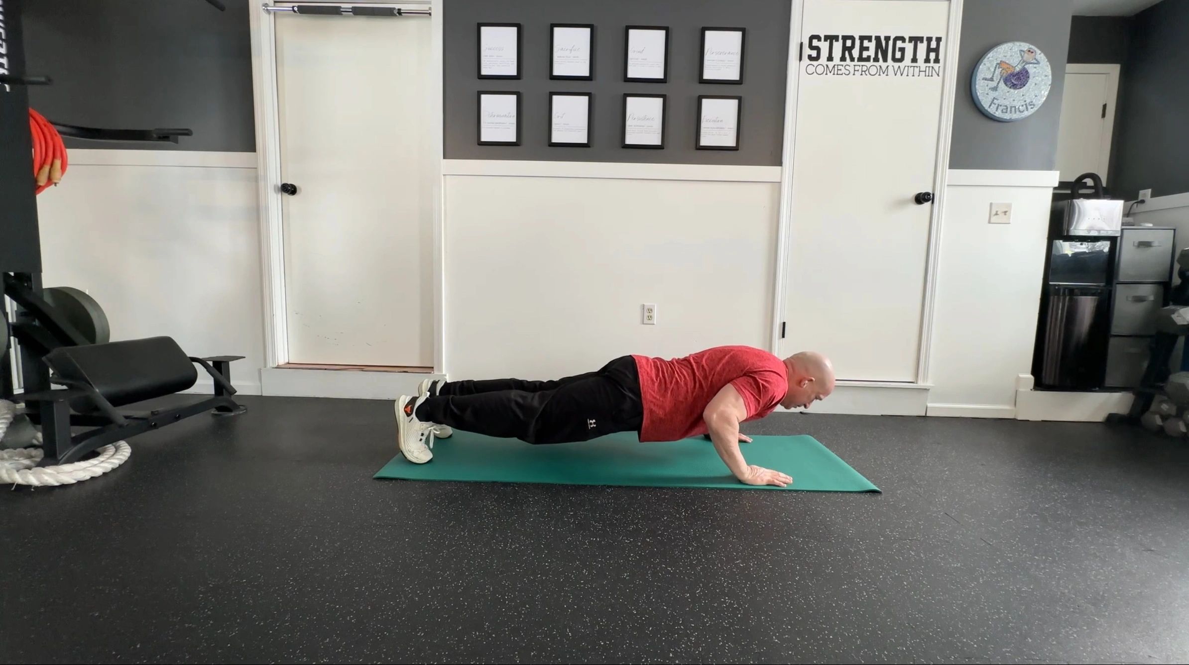 Fitness trainer performing a core exercise engaging the total body for online training