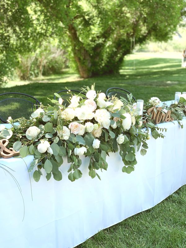 tablecloth with white flowers and green leaves