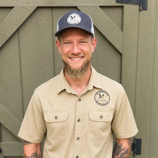 Smiling man in a construction uniform.