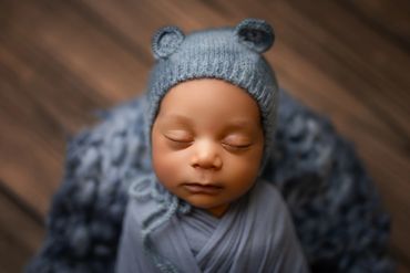 sweet newborn boy in blue during his newborn session in corona, ca photography studio.