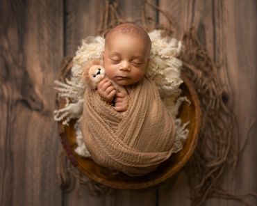 baby boy wrapped in browns during his luxury newborn session in yorba Linda ca,