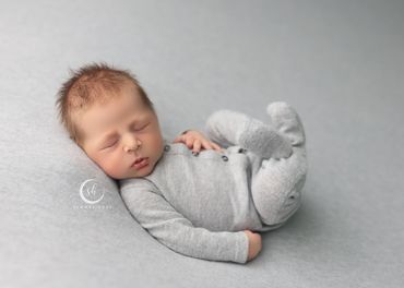 baby boy all cozy during studio newborn session at the best inland empire studio in Corona, ca.