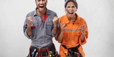 Two excited construction workers celebrating success with fists clenched.