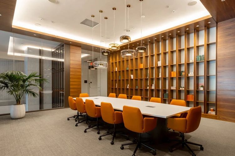 Large comfortable conference room, large table, wood shelves.