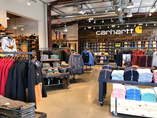 Inside a Carhartt clothing store with various apparel displays.