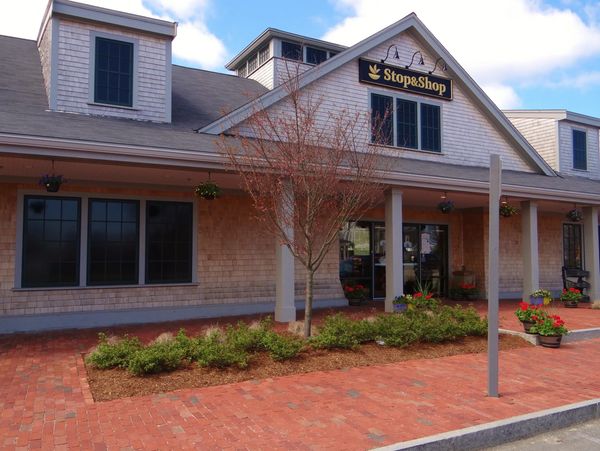 Exterior view of a Stop & Shop store with a brick walkway and landscaping.