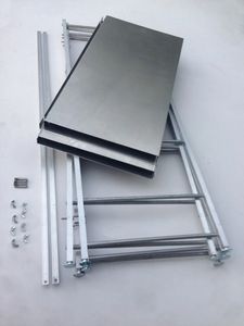 photo of a portable shelf display tower collapsed down to 4 side ladders, crossbrases and 4 aluminum shelves nested to show how compact it is.