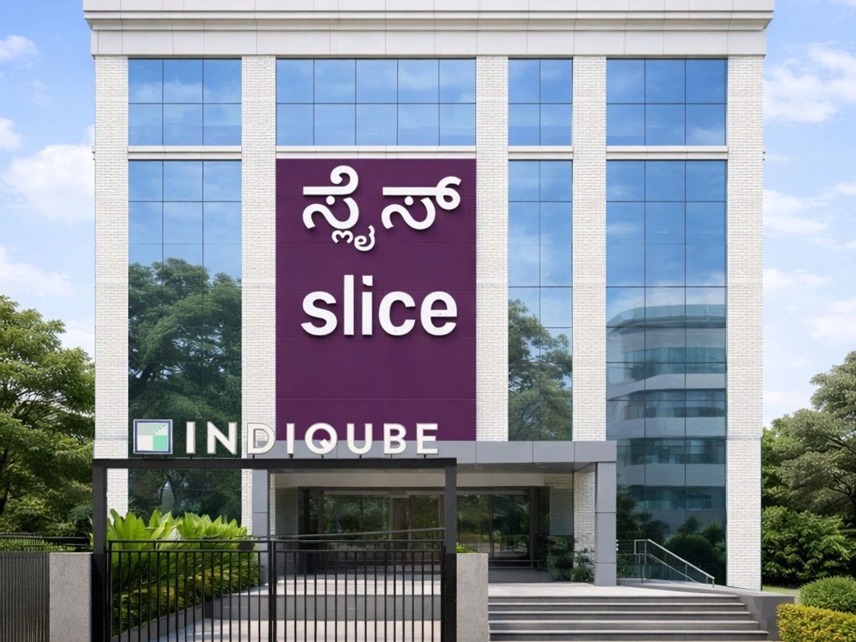 Modern office building with large glass windows and company signs.
