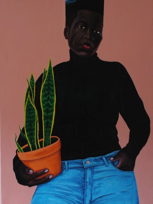 Portrait of a person holding a potted plant against a peach background.