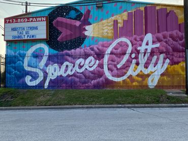 space city mural on side of pawn shop