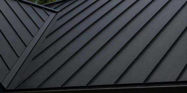 Modern black metal roofing with clean geometric lines.
