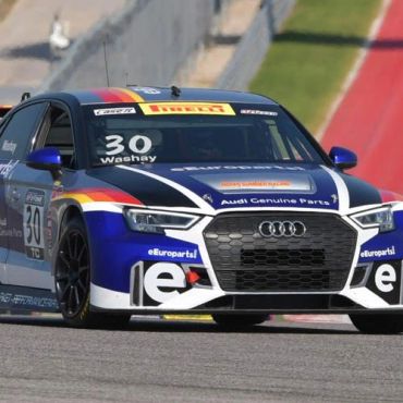 Audi racecar number 30 on the racetrack.