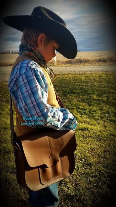Henry with his leather messenger bag that he designed and made.
