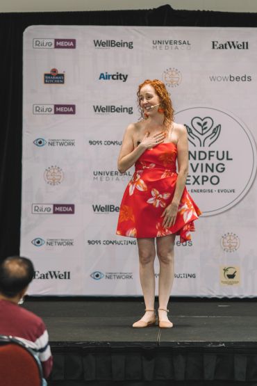Wellness speaker Leanne Zaccar on stage during an motivational talk at wellbeing expo