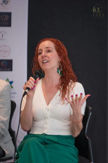 Event speaker Leanne Zaccar on stage sharing wisdom about health and wellbeing for yoga day