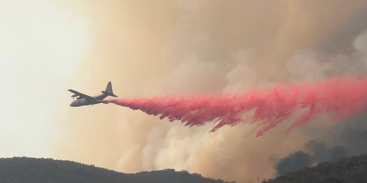 Fire Fighting plane drops Fire Retardant  on the northern perimeter of El Cariso Village- Holy Fire
