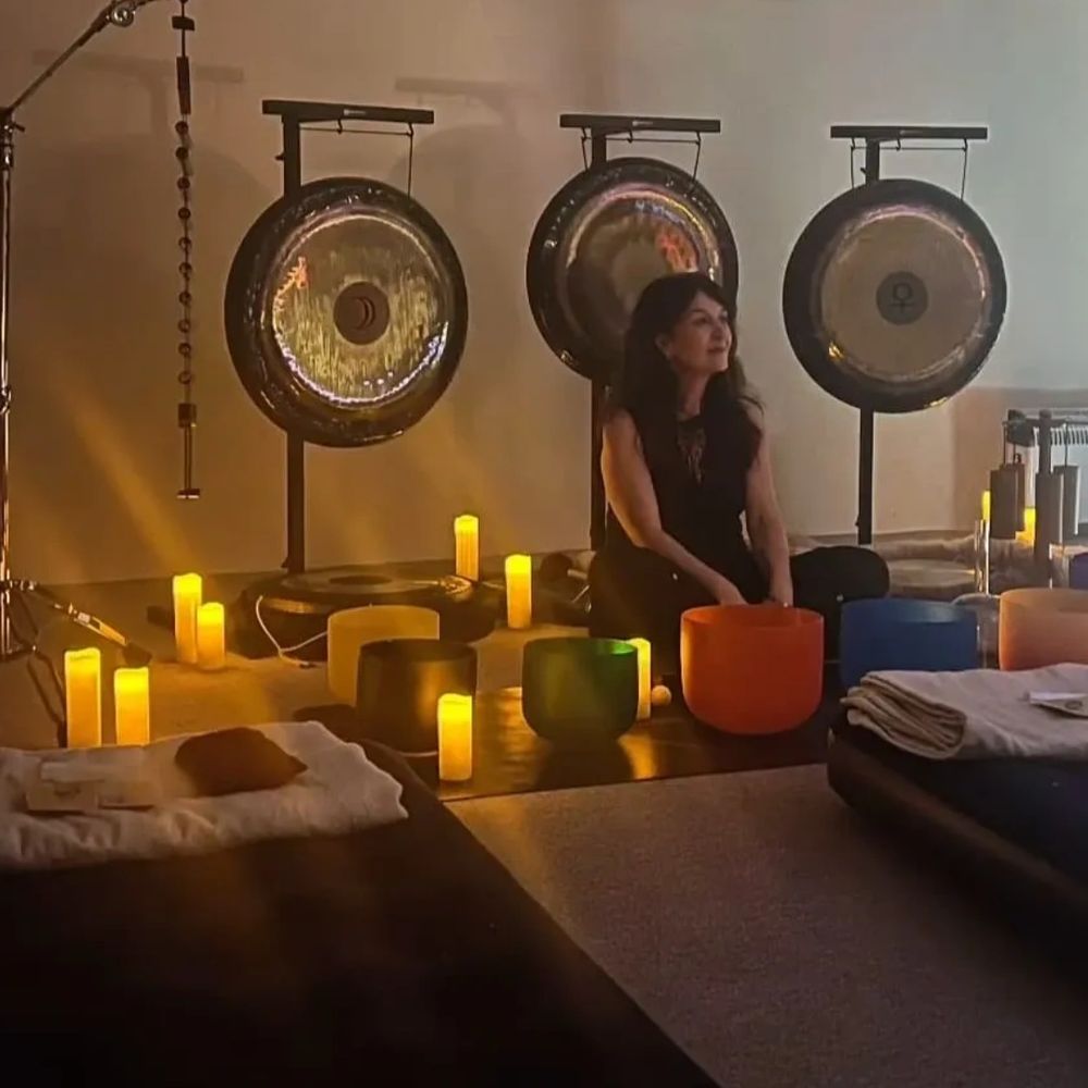 lady sat in front of gongs