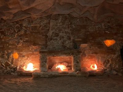 Three indoor fireplaces filled with Himalayan salt rocks, creating a warm, tranquil ambiance.