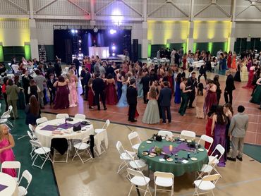A lively prom night with students dancing and chatting.