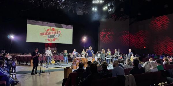 Church worship band performing on stage during Thanksgiving Eve service.