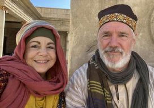 A smiling couple in biblical costumes.