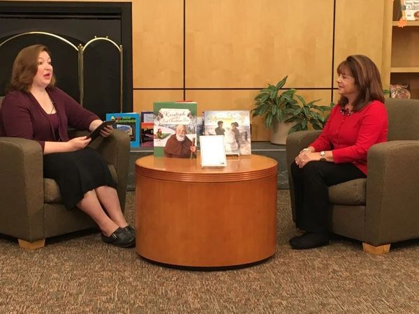 women sitting on a sofa talking to each other
