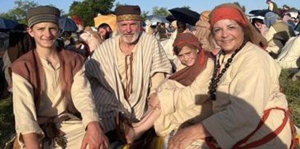a family sitting in the mountant