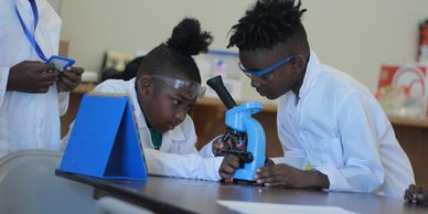 STEM Science Class for kids using a microscope.
