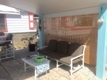 Seating area outside in the back of a house.