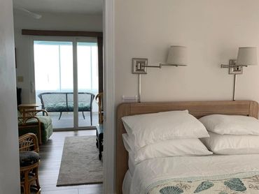 A bedroom with a neatly made bed.