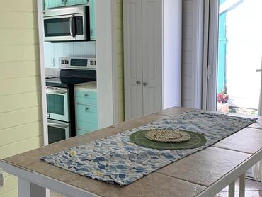 Dining room with a tall table that seats six people.