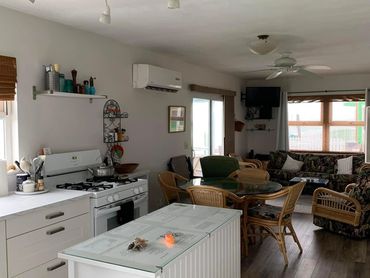 Kitchen of a house with a gas stove, oven and island area.