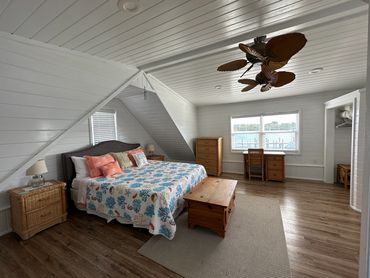 Huge bedroom with a king bed, neatly made.