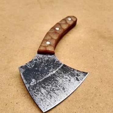 Rustic cleaver knife with a wooden handle on a plain surface.