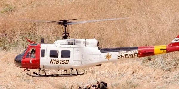 Red and white helicopter grounded.