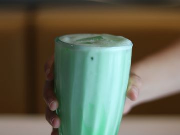 A foamy green drink