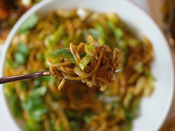 A Hakka Noodle scooped up on a fork