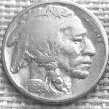 Close-up of a 1926 Buffalo nickel on a textured surface.