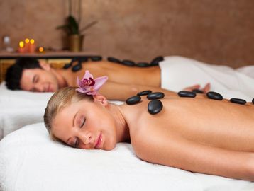Couple enjoying a relaxing hot stone massage together.