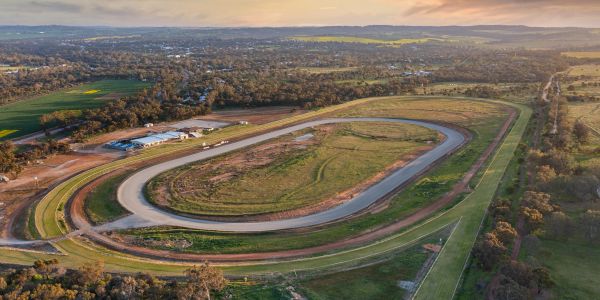 Aerial view of a rural race track at sunset.