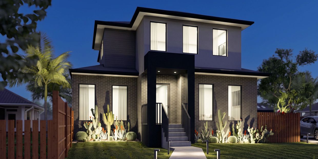 Modern two-story house at dusk with cacti landscaping.