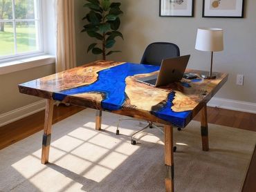 A custom wood desk with striking blue epoxy resin