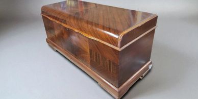 Vintage wooden box with a glossy finish and intricate grain patterns.