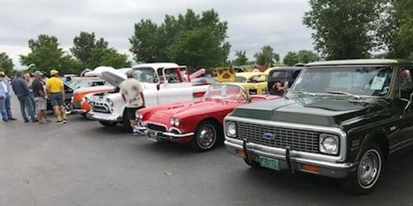 Car show Featuring a Corvette and a Chevy Cheyenne