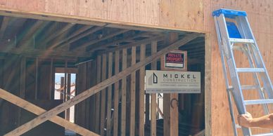 Wooden framing and plywood walls at a residential construction site.