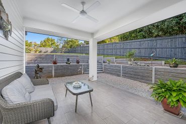 Cozy outdoor patio with seating and plants.