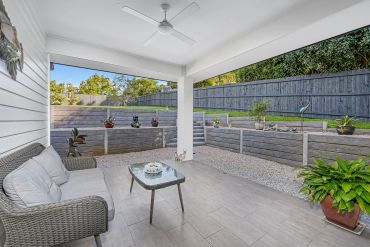 Cozy patio with seating and garden view.