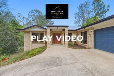 A modern brick house with a driveway and a garage.