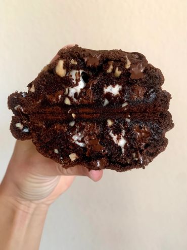 Soft baked chocolate almond base cookie with toasted almond pieces and gooey marshmallow