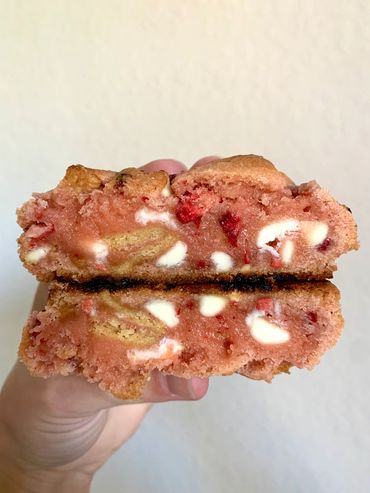 Soft baked strawberry base cookie with white chocolate chips and golden Oreo cookie pieces